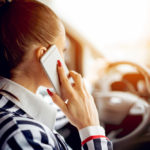 buiness woman talking on phone while driving