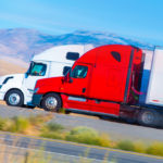 Two Tractor trailer trucks.jpg.crdownload