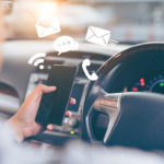 Man using smartphone while driving the car