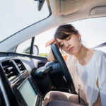 young female driver sleeping in vehicle