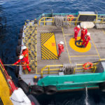 Maritime workers are transported on a vessel to offshore rigs in The South China Sea