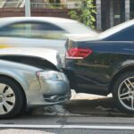 Car collision on city street. car crash accident. Two damaged automobiles